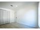 Bright bedroom features wood-look floors, closet, and a crisp, neutral color palette at 5907 Sussex Ct, Tampa, FL 33615