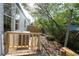 Home exterior shows the side deck with a wood railing, side yard and access to the backyard at 5907 Sussex Ct, Tampa, FL 33615