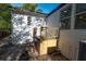 Exterior side view of home with stairs leading up to the side entrance and window at 5907 Sussex Ct, Tampa, FL 33615