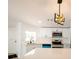 Bright kitchen featuring stainless steel appliances, white cabinetry, and a modern light fixture at 5907 Sussex Ct, Tampa, FL 33615