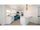 Stylish kitchen with stainless appliances, white cabinets, peninsula, and modern fixtures at 5907 Sussex Ct, Tampa, FL 33615