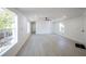 Open living room with new wood flooring and ample natural light from large windows at 5907 Sussex Ct, Tampa, FL 33615
