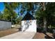 Neat backyard shed with black trim, offering extra storage space and organization at 5907 Sussex Ct, Tampa, FL 33615