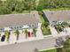 Aerial view of townhomes with well-manicured lawns and tree lined streets at 8661 Daydream St, Sarasota, FL 34238