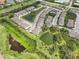 Aerial view of the neighborhood with pond, pool, and lots of landscaping at 8661 Daydream St, Sarasota, FL 34238