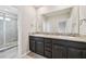 Bathroom vanity features double sinks, granite countertop, and dark wood cabinets at 8661 Daydream St, Sarasota, FL 34238
