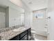 This bathroom features white tile, a bathtub, and granite countertops at 8661 Daydream St, Sarasota, FL 34238