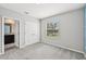 This bedroom features a window, carpet, and a view of the bathroom at 8661 Daydream St, Sarasota, FL 34238