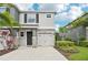 Two-story home featuring a stone-accented facade, attached garage, and well-maintained landscaping at 8661 Daydream St, Sarasota, FL 34238