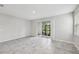 Spacious living room featuring neutral tile flooring, sliding glass doors, and a bright, airy feel at 8661 Daydream St, Sarasota, FL 34238