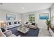 Bright living room featuring modern furniture, stylish decor, and sliding glass doors to outdoor space at 8661 Daydream St, Sarasota, FL 34238