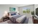 Inviting primary bedroom featuring a king bed, soft lighting, and a large window with natural views at 8661 Daydream St, Sarasota, FL 34238