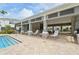 Stunning pool area with comfortable lounge chairs and a covered patio with shade at 8661 Daydream St, Sarasota, FL 34238