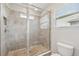 Walk-in shower features glass doors, tiled walls, and tile flooring at 8661 Daydream St, Sarasota, FL 34238