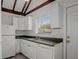 Cozy kitchen featuring white cabinets, sleek countertops, and a bright window at 5641 Ashley Oaks Dr # 39, Tampa, FL 33617