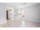 Bright and airy living area with tile floors, ceiling fan, and kitchen access at 5641 Ashley Oaks Dr # 39, Tampa, FL 33617