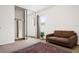 Cozy living room with a brown couch, decorative rug, and a sliding closet door at 5641 Ashley Oaks Dr # 39, Tampa, FL 33617
