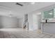 Open-concept living room with tile floors, ceiling fans, and access to kitchen at 5641 Ashley Oaks Dr # 39, Tampa, FL 33617