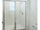 Modern shower with clear glass doors, white tile and updated fixtures at 6204 Camino Dr, Apollo Beach, FL 33572