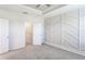 Bright bedroom featuring a decorative accent wall, trey ceiling, and an open walk-in closet at 6204 Camino Dr, Apollo Beach, FL 33572