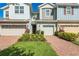 Charming townhome exterior features colorful siding, two-car garage, and well-maintained landscaping at 6204 Camino Dr, Apollo Beach, FL 33572