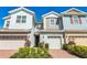 Charming townhome exterior features colorful siding, two-car garage, and well-maintained landscaping at 6204 Camino Dr, Apollo Beach, FL 33572
