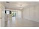 Bright, open-concept living space with tile floors, designer lighting and stylish shiplap accent wall at 6204 Camino Dr, Apollo Beach, FL 33572