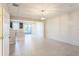 Bright, open-concept living space with tile floors, designer lighting and stylish shiplap accent wall at 6204 Camino Dr, Apollo Beach, FL 33572