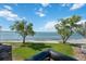 Balcony with black metal railing featuring views of the beach, waterway, and green space at 6210 Sun Blvd # 206, St Petersburg, FL 33715