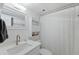 White bathroom with a modern vanity, toilet and bathtub with shower at 6210 Sun Blvd # 206, St Petersburg, FL 33715