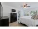 Cozy bedroom with dark dresser, balcony access, and bright windows for natural light at 6210 Sun Blvd # 206, St Petersburg, FL 33715