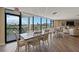 Dining area features multiple tables and chairs, a view of the golf course, and access to the outside at 6210 Sun Blvd # 206, St Petersburg, FL 33715