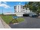 Well-maintained condo building with lush landscaping, prominent signage, and convenient parking spaces at 6210 Sun Blvd # 206, St Petersburg, FL 33715