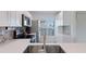Bright white kitchen features stainless appliances and white cabinets at 6210 Sun Blvd # 206, St Petersburg, FL 33715