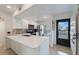 Bright white kitchen features stainless appliances and a breakfast bar with quartz countertop at 6210 Sun Blvd # 206, St Petersburg, FL 33715