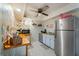 Compact kitchenette featuring stainless steel appliances, bright wallpaper, and flamingo statue at 6210 Sun Blvd # 206, St Petersburg, FL 33715