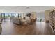 Large lounge with wood floors, sectional sofa, and views of golf course through large windows at 6210 Sun Blvd # 206, St Petersburg, FL 33715