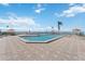 Community pool surrounded by lounge chairs, umbrellas, and views of the waterway at 6210 Sun Blvd # 206, St Petersburg, FL 33715