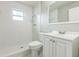 Bright bathroom with a shower, toilet, and sink vanity with a mirror at 1035 S Duncan Ave, Clearwater, FL 33756
