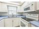 This kitchen features white cabinets, stainless steel appliances, and plenty of counter space at 1035 S Duncan Ave, Clearwater, FL 33756