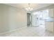 Dining area with tile floors; opens to kitchen with white cabinets and appliances at 1035 S Duncan Ave, Clearwater, FL 33756