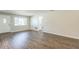 Bright living room with wood-look flooring, neutral paint, white trim, and a large window at 1035 S Duncan Ave, Clearwater, FL 33756