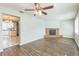 Bright living room featuring wood-look flooring and a beautiful brick fireplace at 1035 S Duncan Ave, Clearwater, FL 33756