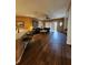 Open living room features wood floors, ceiling fan, and sliding doors to the outside at 1829 Mira Lago Cir, Ruskin, FL 33570