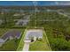Aerial view of a beautiful single-story home surrounded by lush greenery, framed by boundary lines at 14256 Salvatierra Ln, Port Charlotte, FL 33981