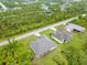 An aerial view showcases the neighborhood homes nestled in a lush green, tranquil wooded area at 14256 Salvatierra Ln, Port Charlotte, FL 33981