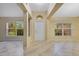 Bright foyer featuring neutral tile flooring, natural light from windows, and a welcoming entryway at 14256 Salvatierra Ln, Port Charlotte, FL 33981