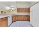 Kitchen featuring wood cabinetry, neutral countertops and white appliances at 14256 Salvatierra Ln, Port Charlotte, FL 33981