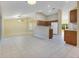 Living room with access to the kitchen featuring tiled floors and a breakfast bar at 14256 Salvatierra Ln, Port Charlotte, FL 33981