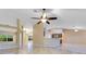 Open-concept living area with tile floors, connecting to the kitchen, featuring natural light and modern fixtures at 14256 Salvatierra Ln, Port Charlotte, FL 33981